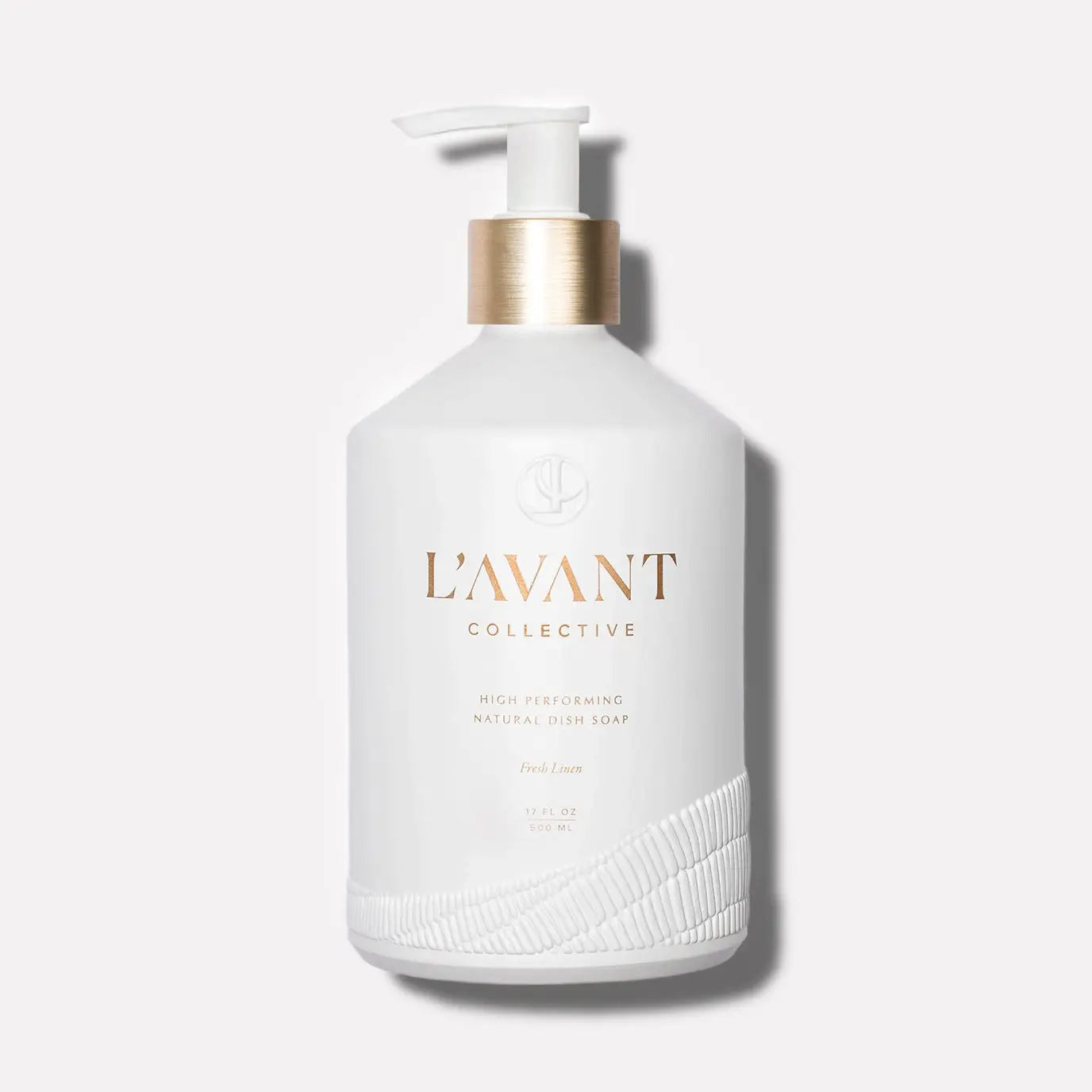 White bottle with pump labeled 'L'Avant Collective' on a light gray background