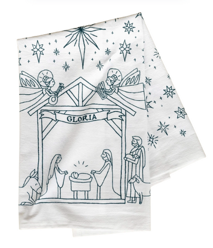 White towel with black nativity scene illustration and 'Gloria' text on a white background