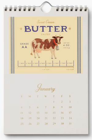 Calendar with a cow illustration and 'Sweet Cream Butter' label design on a beige background.