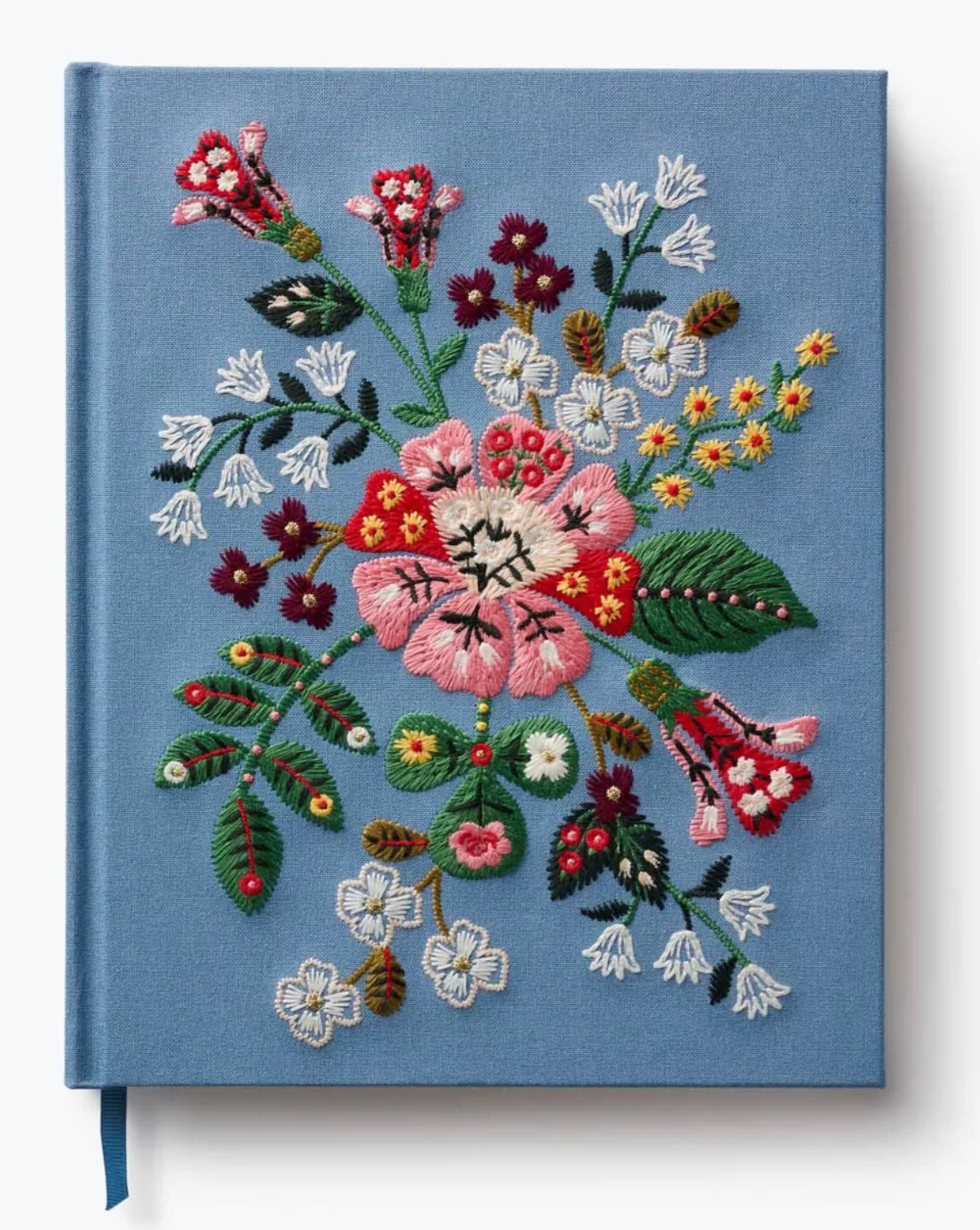 Book with floral embroidery on a blue background
