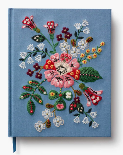 Book with floral embroidery on a blue background