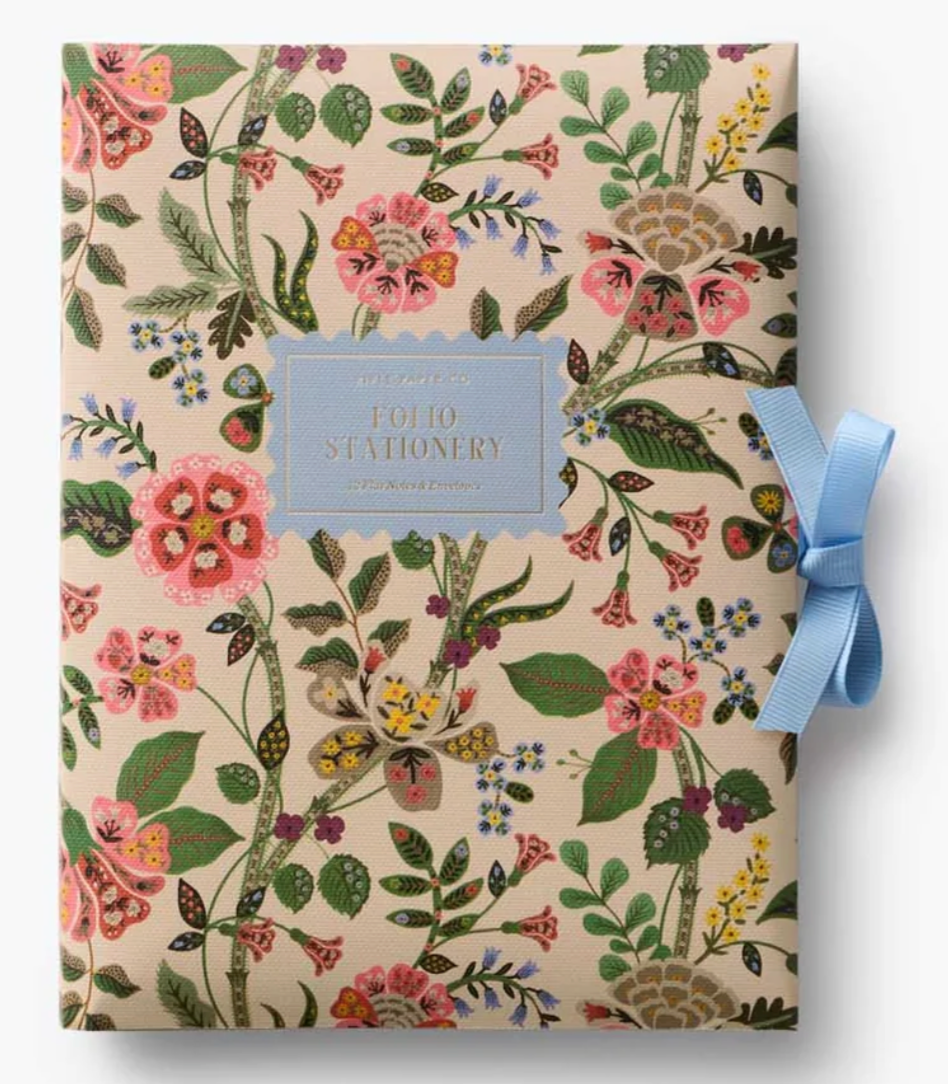 Floral-patterned stationery set with a blue ribbon on a white background