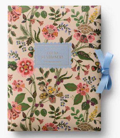 Floral-patterned stationery set with a blue ribbon on a white background