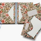 Floral patterned stationery set with envelopes and cards on a white background