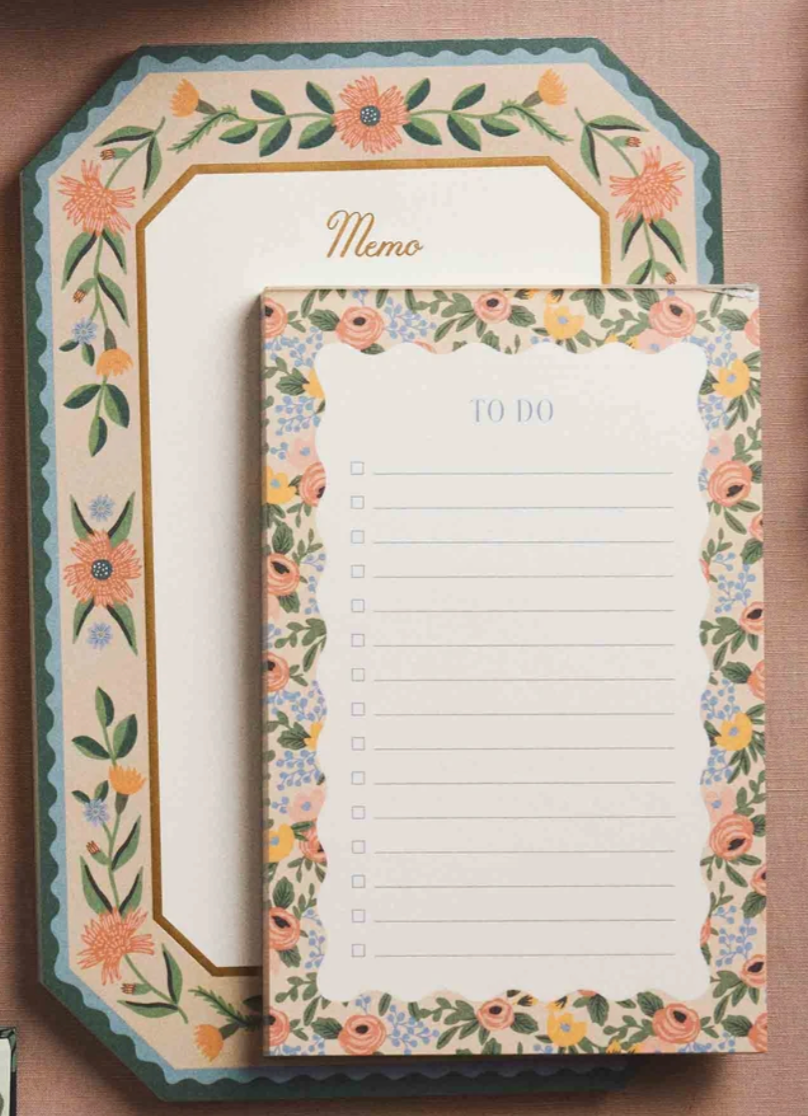 Floral-themed memo pad with decorative border on a brown background