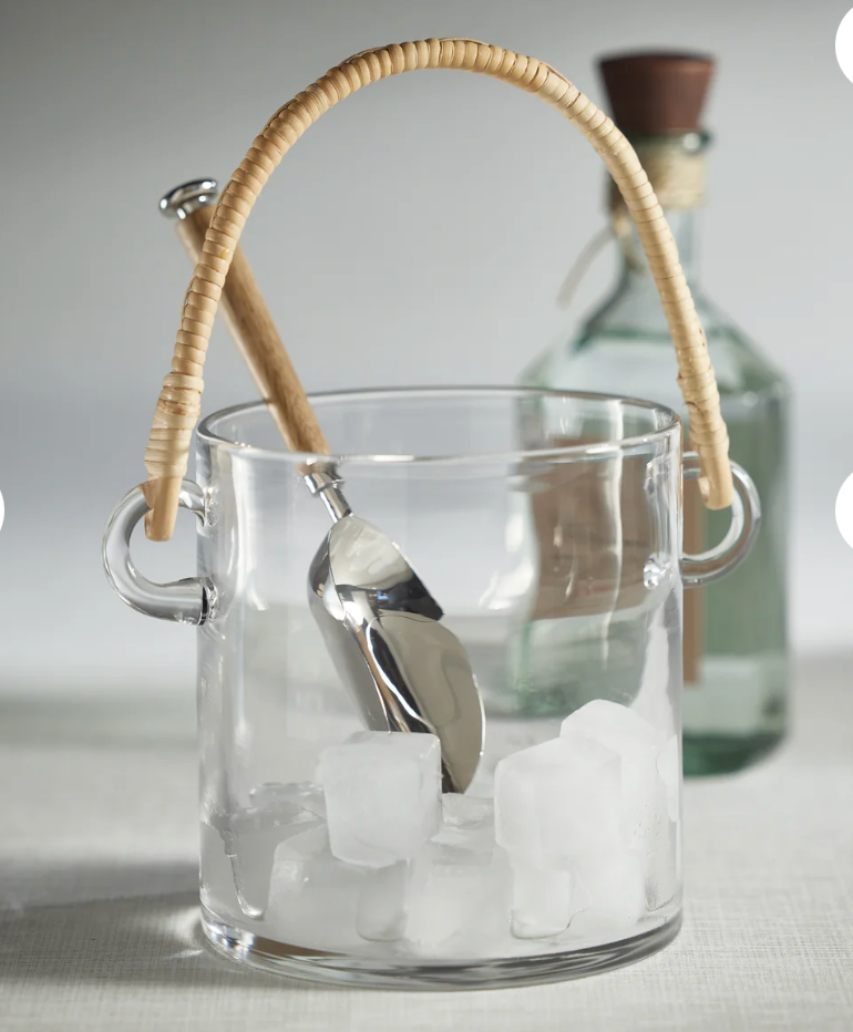Clear glass ice bucket with a wooden handle and metal scoop, containing ice cubes.