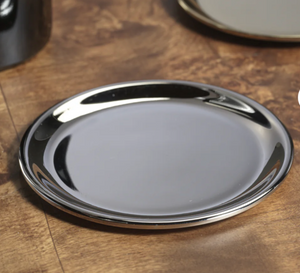 Silver wine bottle coaster on a wooden surface