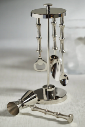Set of silver cocktail shakers and tools on a white background