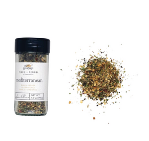 Jar of 'Mediterranean' spice blend with visible spices spilling out on a white background