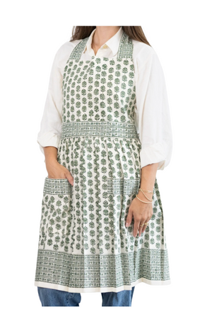 Woman wearing a white kurta with green floral pattern on a white background