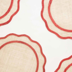 Close-up of woven placemats with red edges on a white background