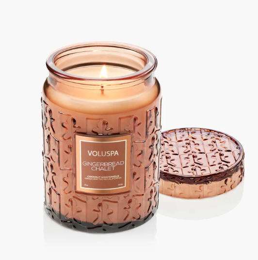 Candle in a decorative jar with a lid, featuring the Voluspa brand.