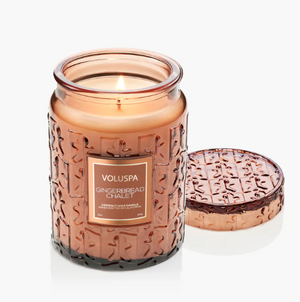 Candle in a decorative jar with a lid, featuring the Voluspa brand.