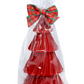 Red layered cake with a plaid bow on top, wrapped in clear cellophane against a white background