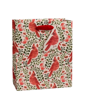 Gift bag with red cardinal bird and floral pattern on a white background