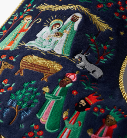 Embroidered nativity scene with Mary, Joseph, baby Jesus, and animals on a dark blue background.