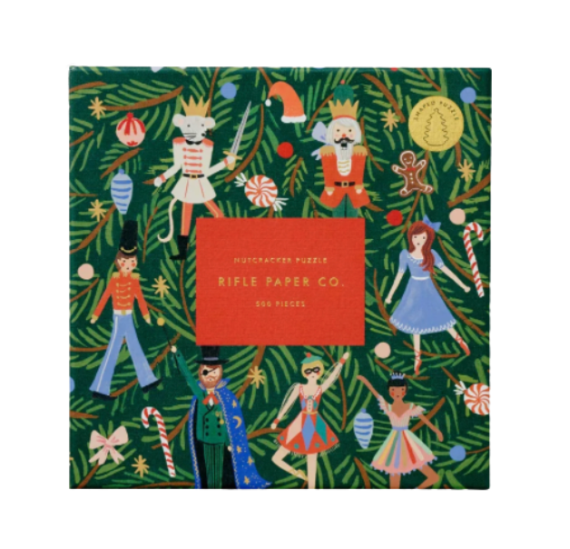 Rifle Paper Co. Nutcracker puzzle packaging with festive illustrations on a green background