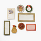 Set of Christmas-themed stationery items including cards and place mats on a white background.