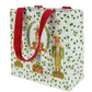 Gift bag with nutcracker design and red handles on a white background