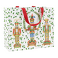 Gift bag with nutcracker design and red handles on a white background