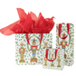 Gift bag with nutcracker design and red tissue paper on a white background