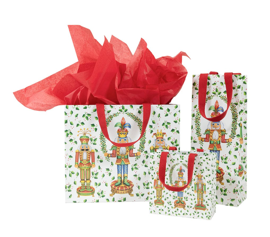 Gift bag with nutcracker design and red tissue paper on a white background