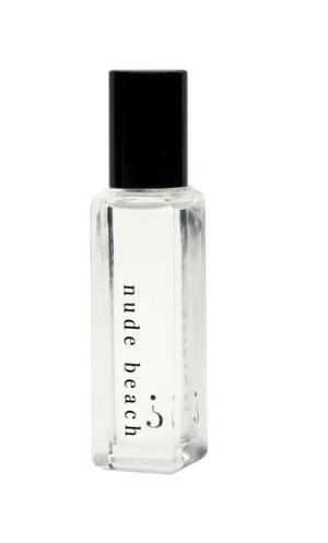 Clear bottle with black cap labeled 'nude beach' on a white background