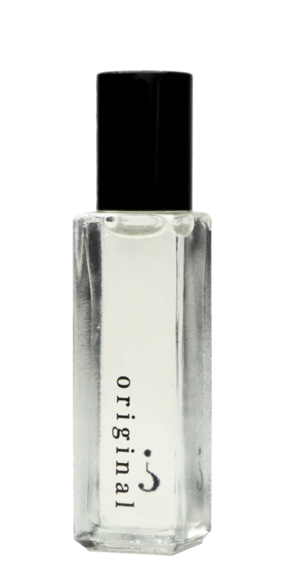 Clear glass perfume bottle with black cap on a white background