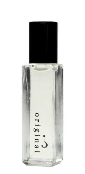 Clear glass perfume bottle with black cap on a white background
