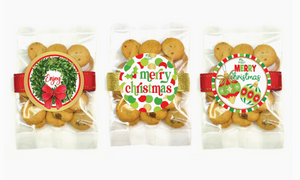 Three packages of cookies with Christmas-themed labels on a white background