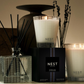 NEST candles and diffuser on a neutral background