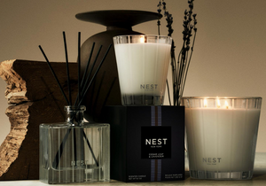 NEST candles and diffuser on a neutral background