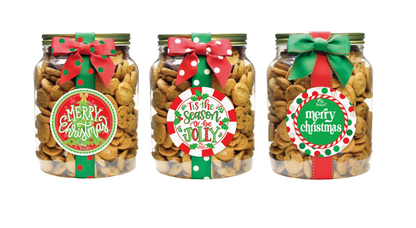 Three jars of cookies with festive labels and ribbons on a white background