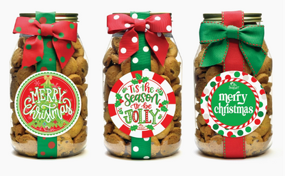 Three jars of cookies with Christmas-themed labels and ribbons on a white background