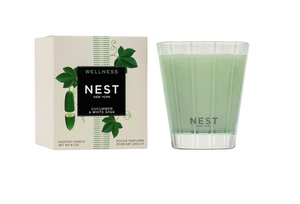 NEST Wellness candle with packaging on a white background