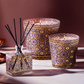 Decorative candles with intricate patterns on a neutral background