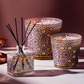 Decorative candles with intricate patterns on a neutral background