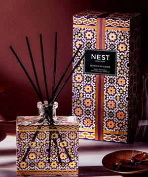 NEST New York Moroccan Amber diffuser with decorative packaging on a dark background