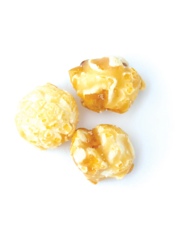 Three pieces of popcorn on a white background