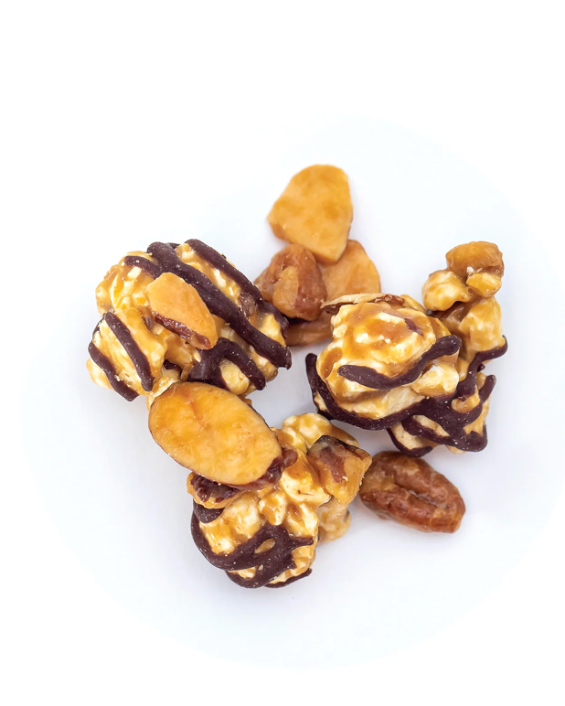 Caramel corn with chocolate drizzle on a white background