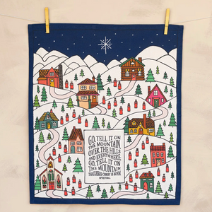 Decorative towel with a winter village scene and Christmas lyrics on a beige background