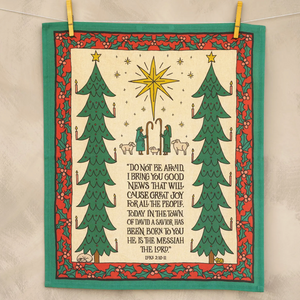 Decorative panel with Christmas trees, star, and nativity scene on a beige background