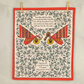 Decorative tea towel with musical instruments and text, framed by red border and holly leaves.