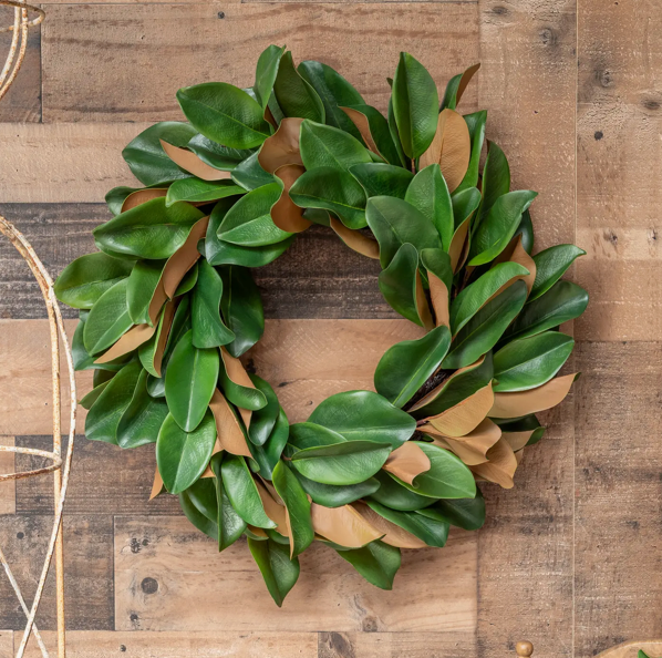 Green and brown leaf wreath on a wooden background