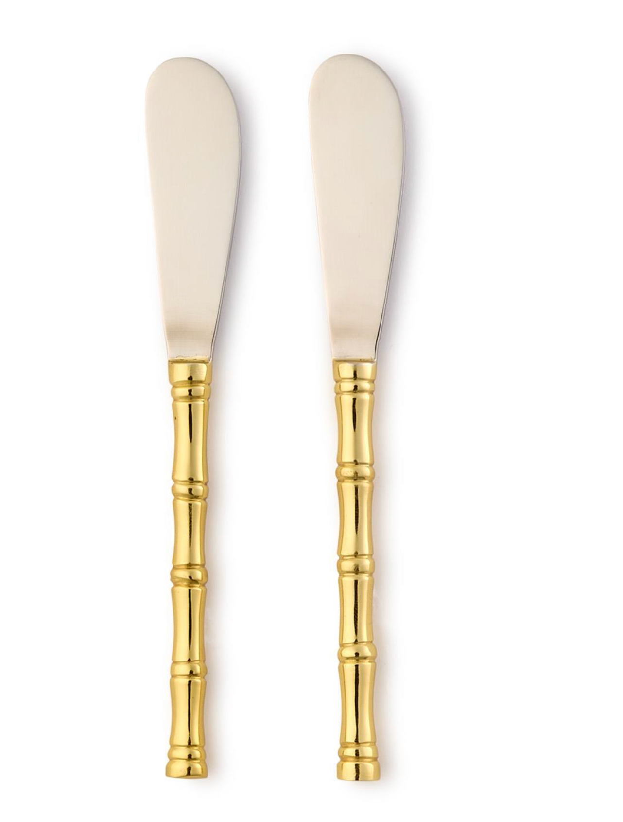 Two cream-colored butter knives with gold bamboo handles on a white background