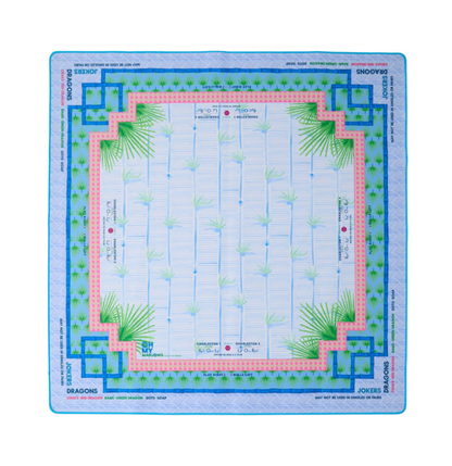 Board game mat with grid layout and decorative palm tree borders on a white background