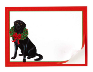 Black dog with a Christmas wreath and bow tie on a white background with a red border.